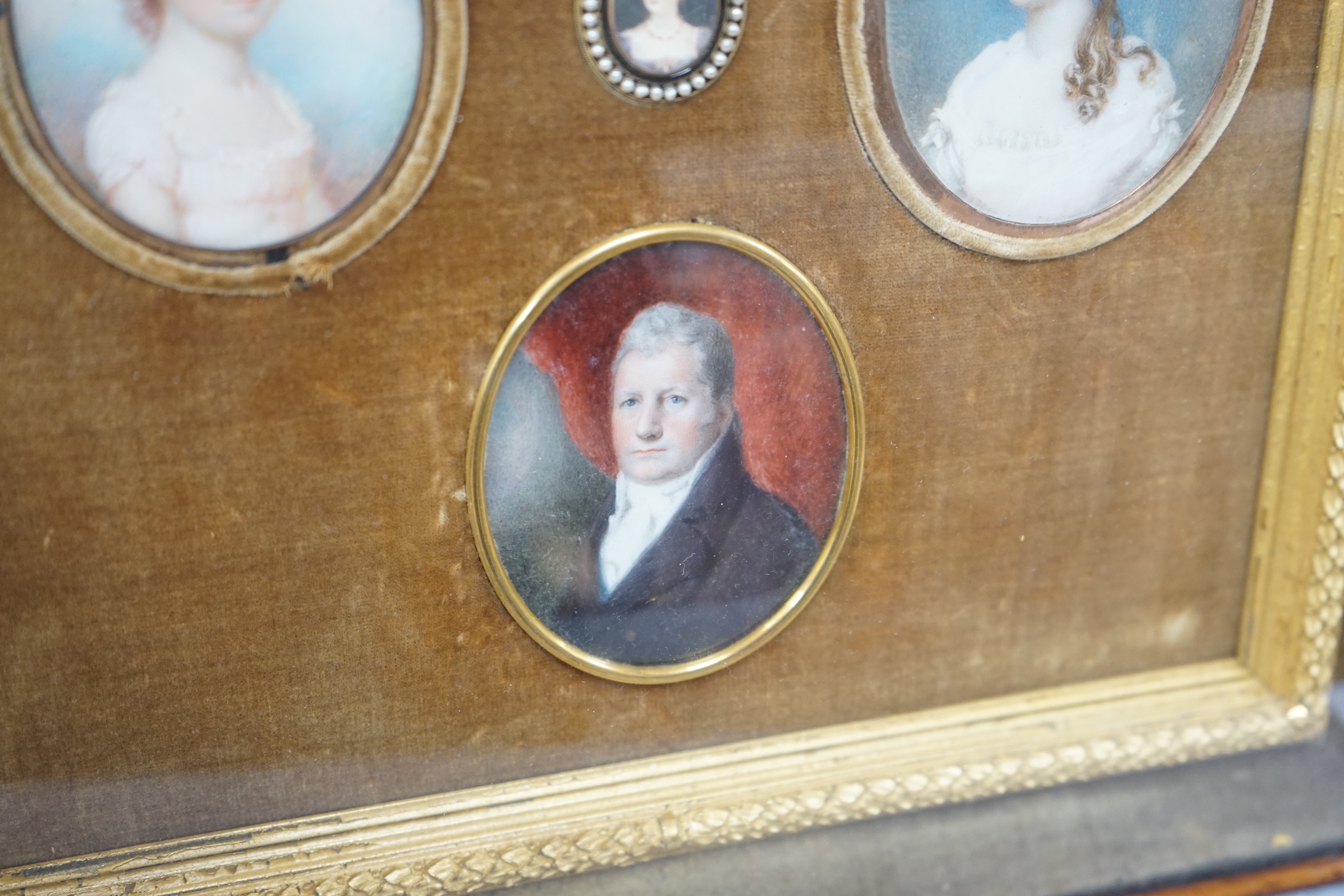 A group of five 19th century portrait miniatures on ivory, framed as one, in a decorative gilt and velvet mount rosewood frame. Overall 36 x 32cm